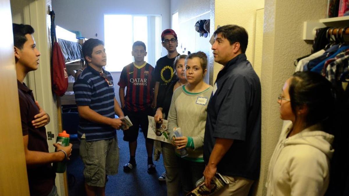 
At left, student Manuel Villarreal, 18, show parents and prospective students his dorm room during a tour of the dorms and facilities at UC Merced Preview Day in 2013. 
