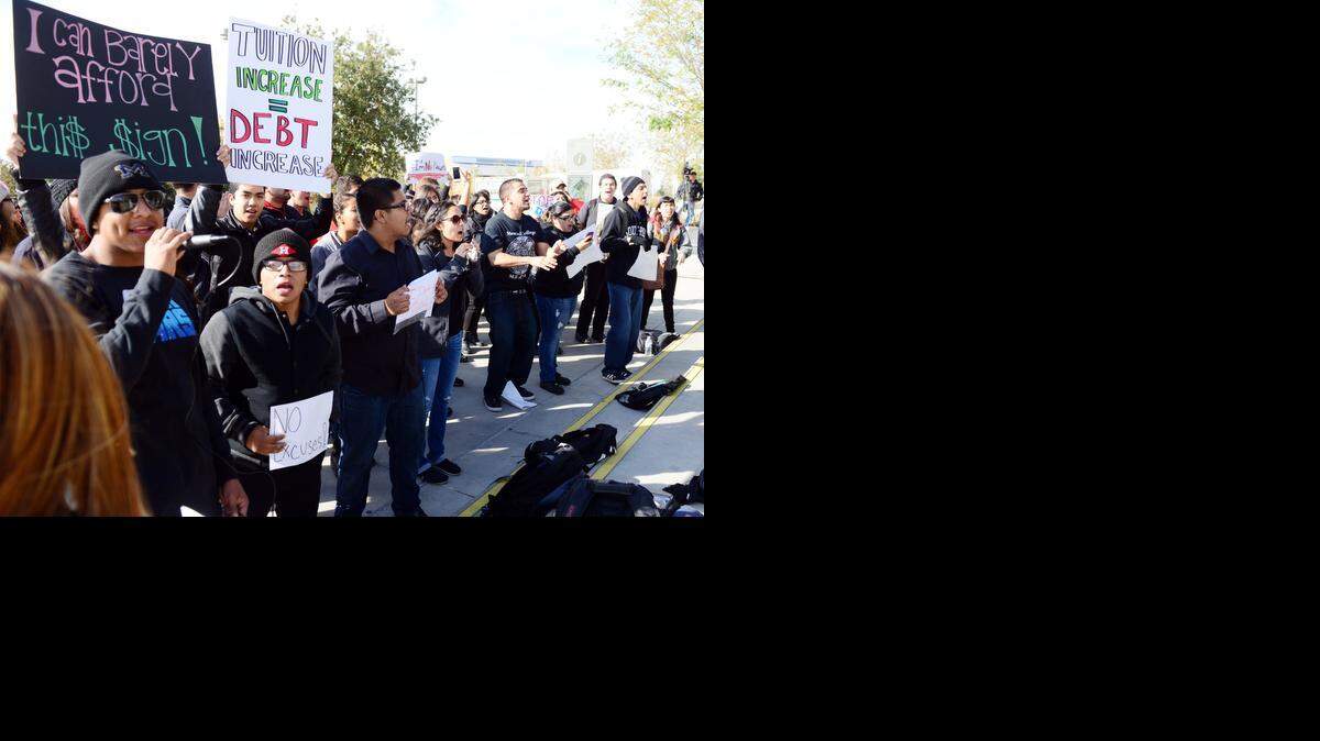 
Almost 100 UC Merced students held a demonstration outside the Kolligian Library on Tuesday to protest to proposed increase to tuition. Students chanted and held signs.
