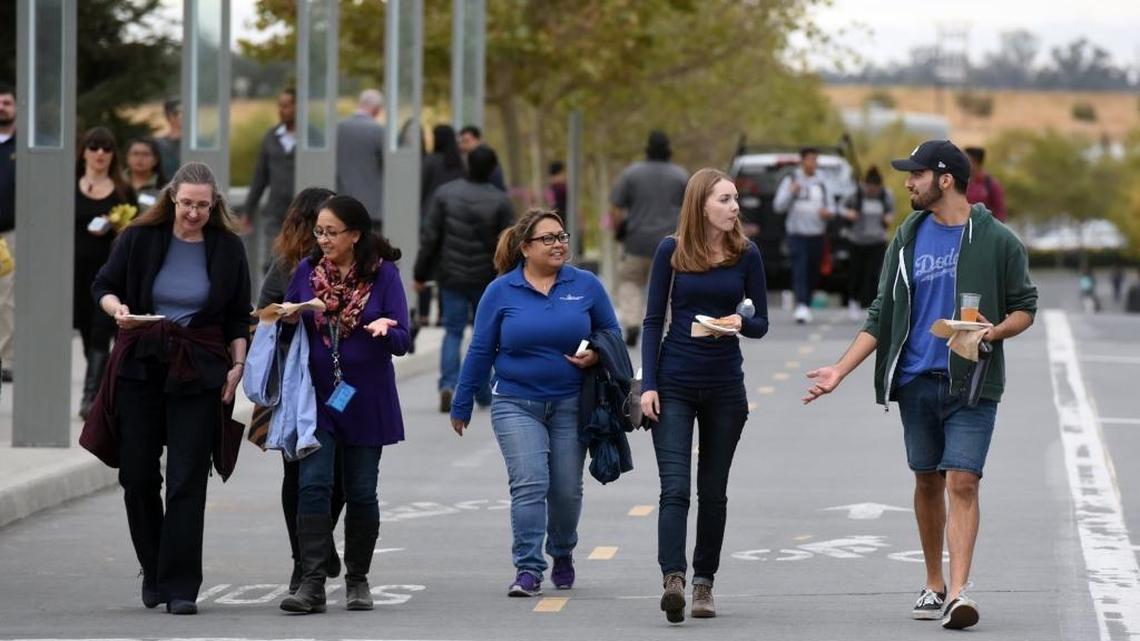 Students and others walk Scholars Lane after the groundbreaking for UC Merced’s 2020 Project on Friday, Oct. 14, 2016.