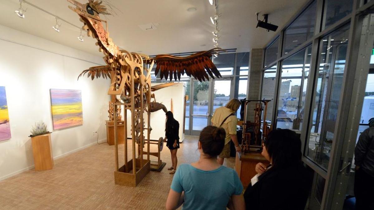 
Two women watch another turn a crank to make “Gearyoptrix” move during a reception at the UC Merced Art Gallery on Thursday, Sept. 24, 2015. The gallery is open from 11 a.m. to 3 p.m. Monday through Thursday.
