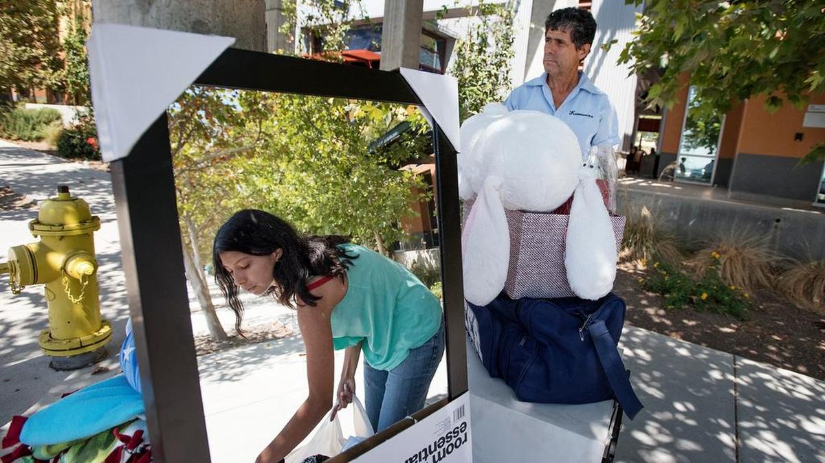 
Arianna de Santiago, 17, of Los Angeles gathers her possessions with the help of her father, Jose, during move-in day at UC Merced on Sunday. More than 2,000 students made the move, with instruction to start Wednesday.

