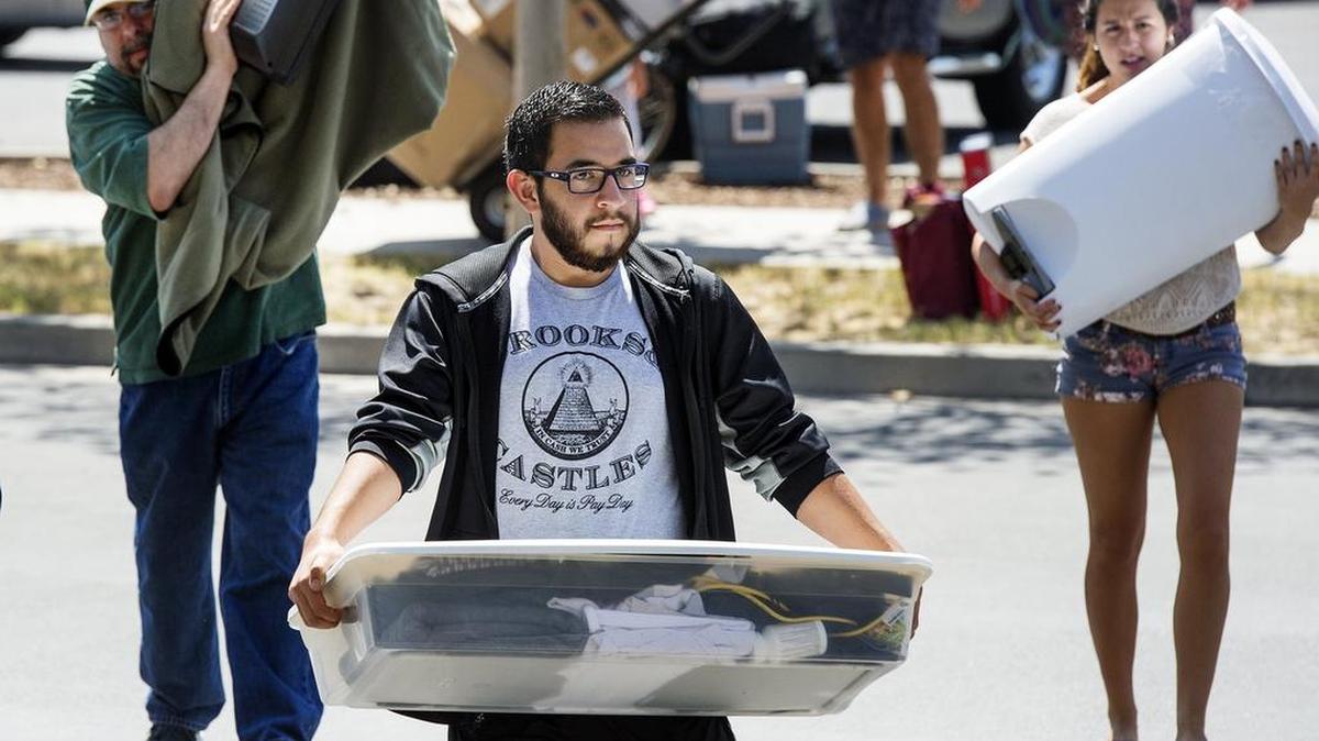 
Andrew Ortiz, 18, of Oxnard carries his belongings into the dorms at UC Merced on Sunday. More than 2,100 students made the move as instruction begins on Wednesday.
