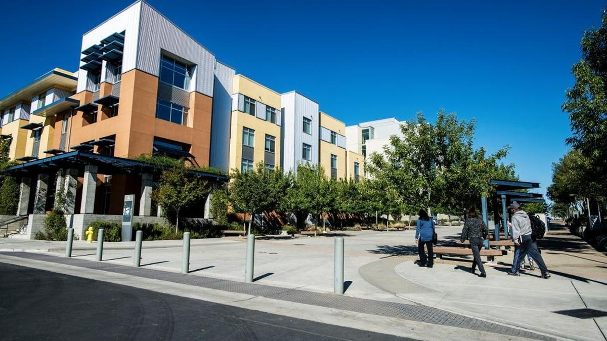 Pedestrians walk past the Tenaya Hall student housing at UC Merced in Merced, Calif., Friday, Nov. 6, 2015.