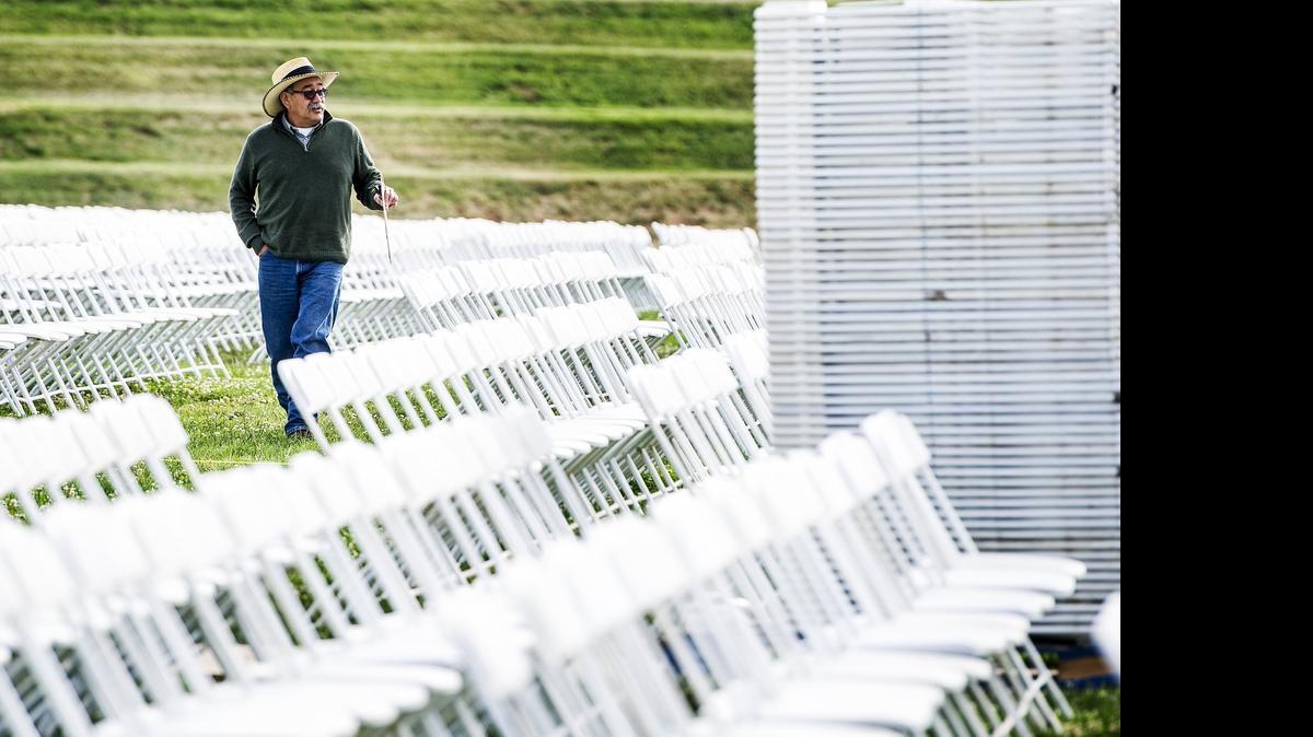
Marcos Pena, 58, of Merced walks through rows of chairs as crews prepare for the UC Merced graduation ceremonies in the campus’s South Bowl in Merced on Thursday. More than 9,000 attendees are expected to watch more than 1,000 students walk the stage during the graduation ceremonies on Saturday and Sunday.

