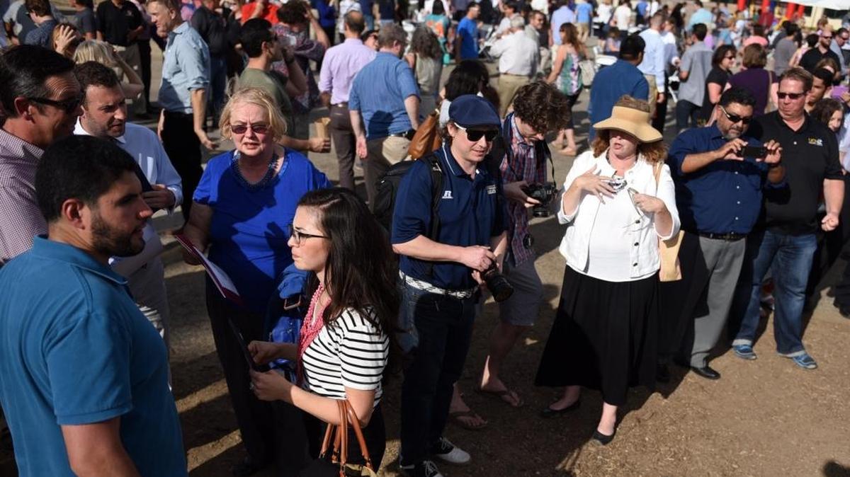A crowd mingles Wednesday, June 8, 2016, in the lot across from Merced City Hall where UC Merced will build the Downtown Center. The university celebrated the groundbreaking the same day with a block party.