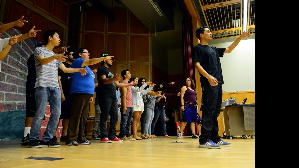
Jose Caballero, 20, far right, a UC Merced management major, leads a group of actors in a call and response Monday for the rehearsal of the Voices of the Revolutionary Theatre Collective. The group will perform two free shows, which feature a number of scenes from plays written during the Black Arts Movement of the 1960s.
