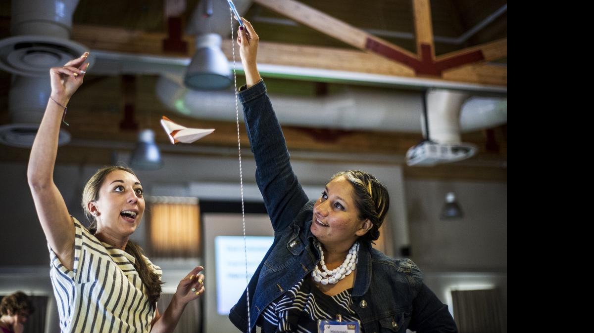 
Hilmar Unified teachers Chelsea Lopes, left, and Ana Maldonado on Tuesday take part in a training exercise to measure the difference in time it takes for a modified piece of paper to fall to the ground during Team-E at UC Merced. Almost 70 teachers participated in the program. which instructs them on how to better teach engineering classes.
