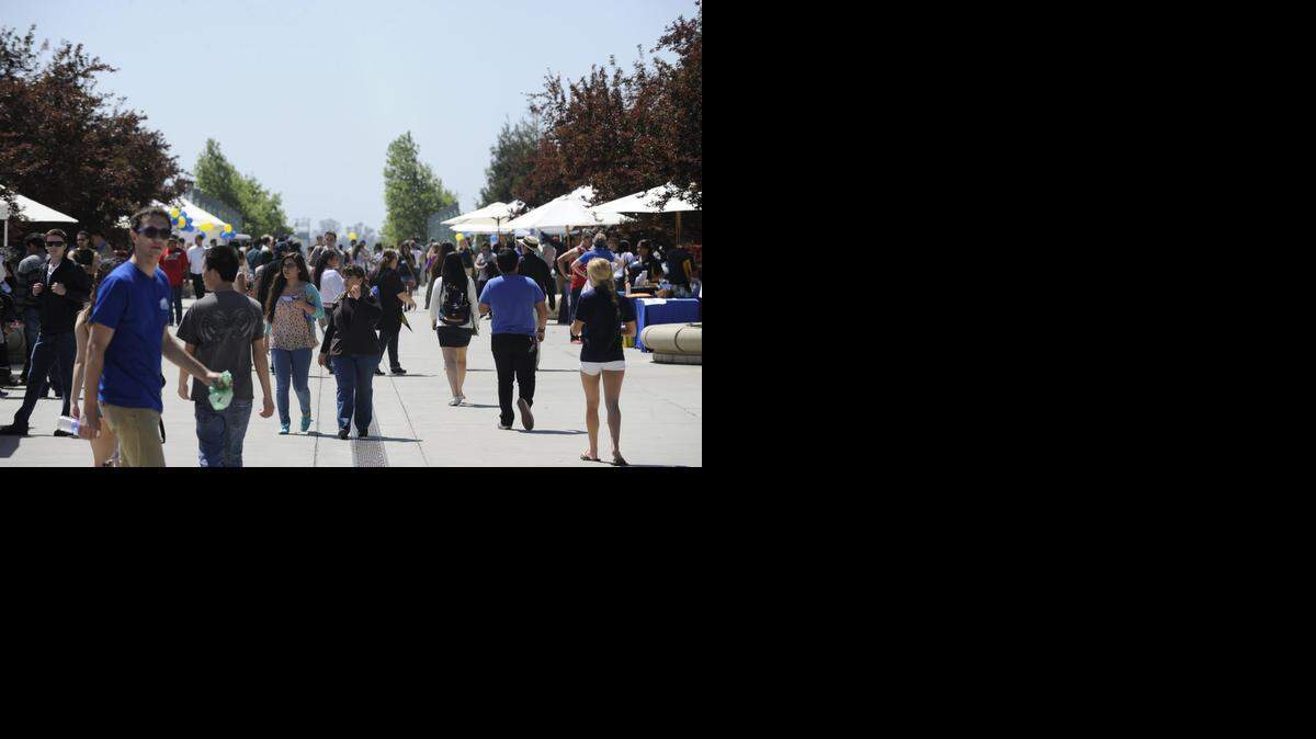 
Hundreds of prospective students walk along the sidewalk in between the quad and Kolligian Library during Bobcat Day at UC Merced last year.
