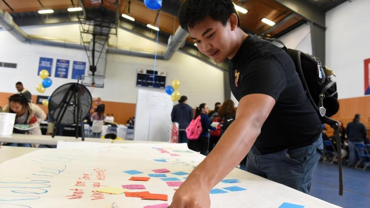Kevin Lao, 20, a mechanical engineering student, answers a question with a sticky note during the UC Merced Wellness Fair on Wednesday, Nov. 2, 2016. School leaders have planned other events this week, the one-year anniversary of a violent attack on campus.