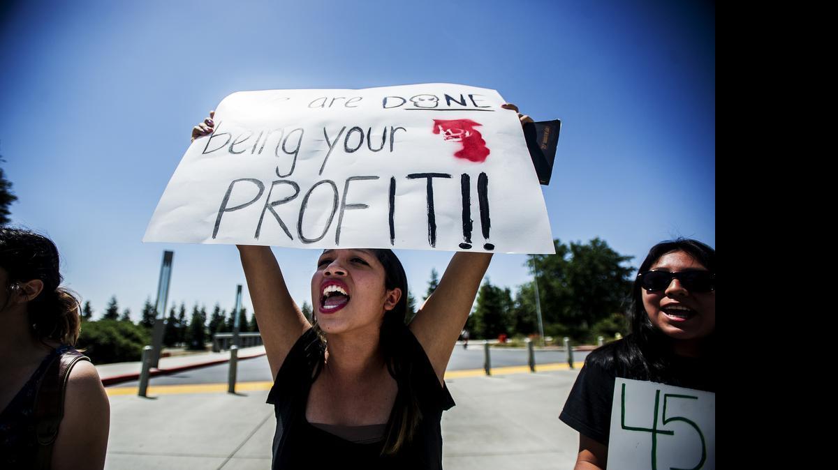 
University of California, Merced, freshman Mitzy Perez, 19, holds a sign reading "We are done being your profit," as she protests with fellow students on Scholars Lane on the university's campus in Merced, Calif., Tuesday, May 5, 2015. The students feel there is a lack of Latino representation on campus and are calling for more Chicano Studies courses taught by Chicano professors. Over 45 percent of the university's enrolled students are Latino.
