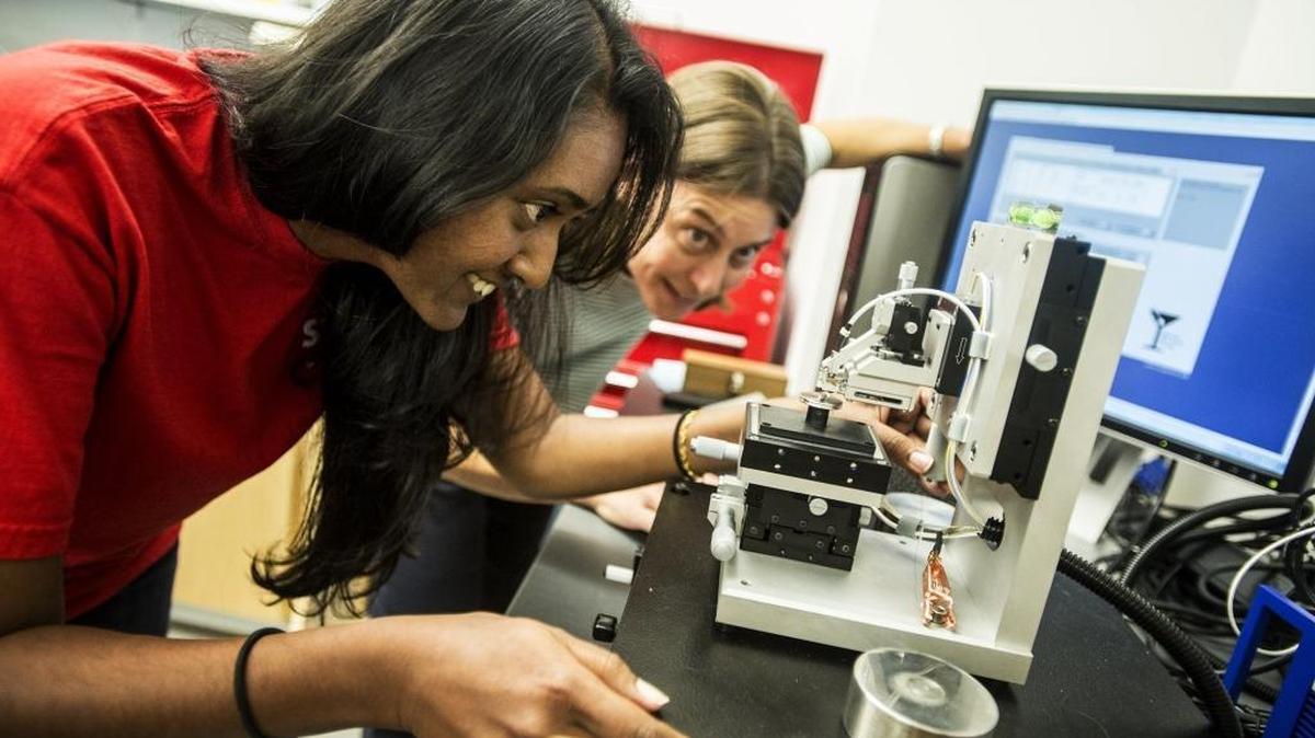 
Uma Ramasamy, 25, left, a UC Merced doctoral student studying tribology, adjusts a tribometer, which measures friction, with the help of Ashlie Martini, associate professor in the School of Engineering, inside Science and Engineering Building 2. 
