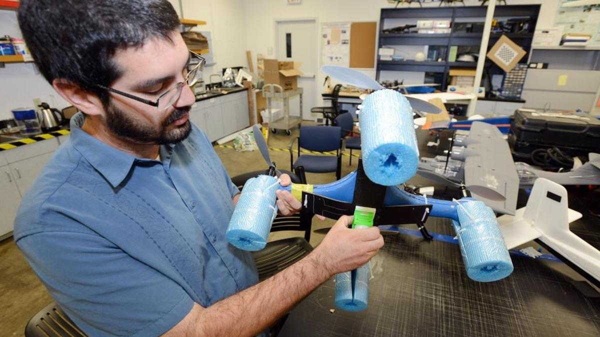 Brandon Stark, a doctorate student at UC Merced, gestures to a water collecting drone, called the “Aquacopter,” inside the university’s MESA lab in 2014. UC Merced has been named as the lead school in determining how drones should be used and regulated across the University of California system.