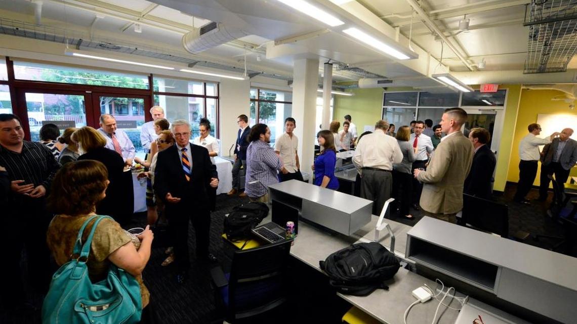 Members of the Merced City Council and others mingle with students and check out the UC Merced Venture Lab, a business incubator, on Sept. 21, 2015.