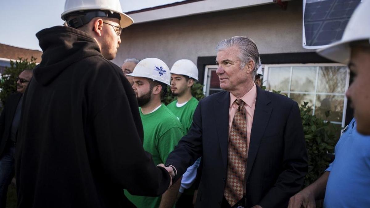 California Superintendent of Public Instruction Tom Torlakson, right, shakes hands with Yosemite High School student Richard Vargas, 18, of Atwater while visiting a home on Marthella Avenue on Tuesday, March 22, 2016, where students are installing solar panels under the supervision of GRID Alternatives in Merced, Calif. GRID Alternatives is a nonprofit that works with volunteers and job trainees to provide solar power and energy efficiency to low-income families. Yosemite High School has been awarded a Gold Level of the California Green Ribbon Schools Award. According to the superintendent’s office, the award honors schools that conserve resources while promoting health and environmental literacy.