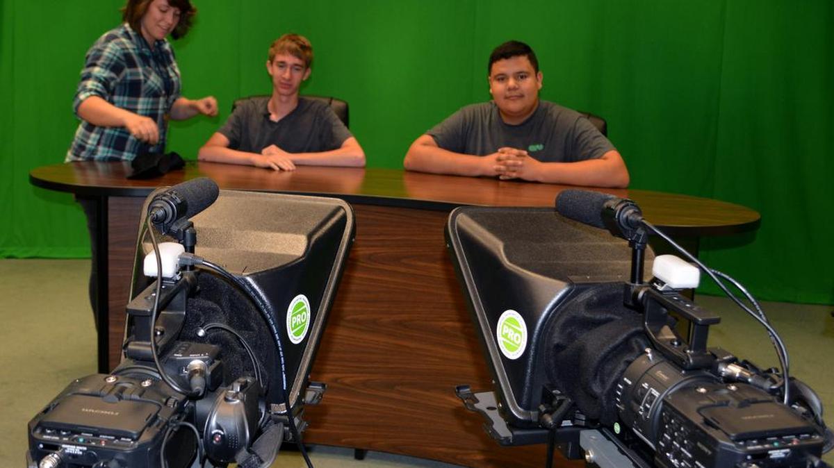 
Viking TV director Haley Pierce, a senior in the broadcast media career concentration, has senior Gage Graves, left, and 2015 program graduate Ignacio Malfabon sit in the anchor chairs as she gives a tour of the studio Sept. 3 at Johansen High in Modesto.
