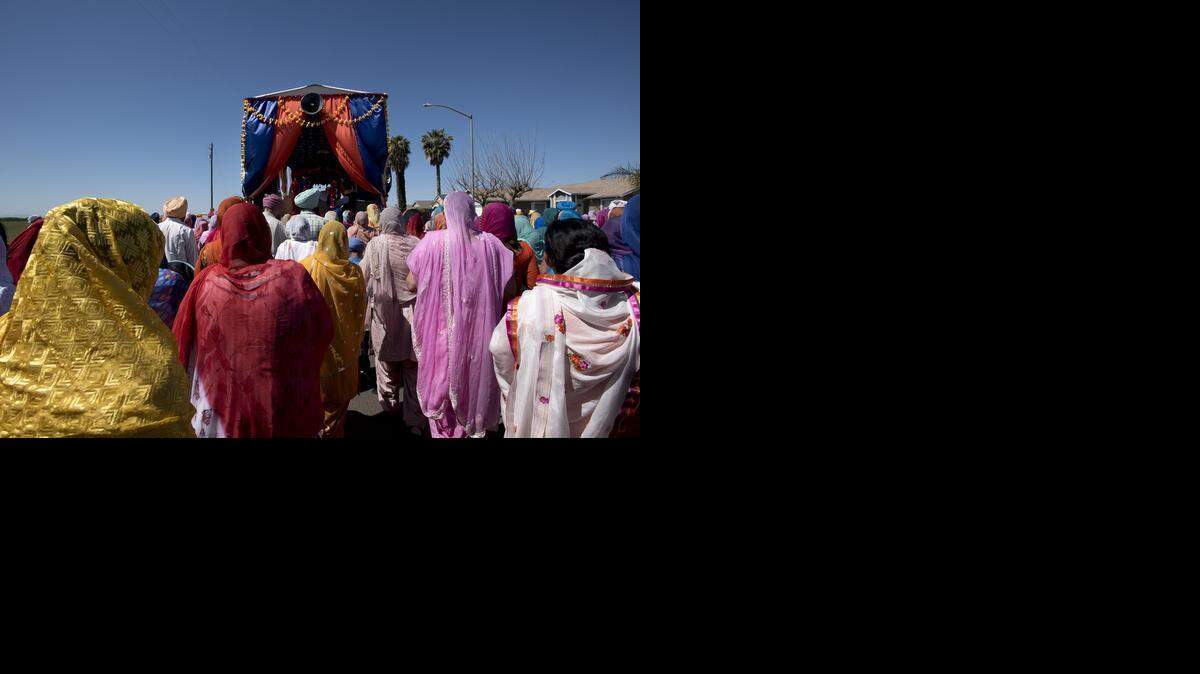 
Members of the Sikh community march with the float that holds the Guru Granth Sahib, the Sikh holy text, as they celebrate the Holla Mahla with a parade in Livingston on Sunday. The parade started at the Gurdwara Sahib Temple and proceeded to the Guru Nanak Temple on B Street, then back again.
