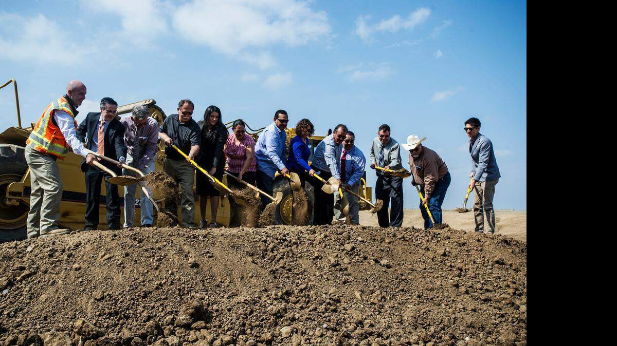Dirt is shoveled during a groundbreaking ceremony at the Planada wastewater treatment plant on Wednesday. The Planada Community Services District proposes to stop dumping into Miles Creek and to use treated wastewater for irrigation.