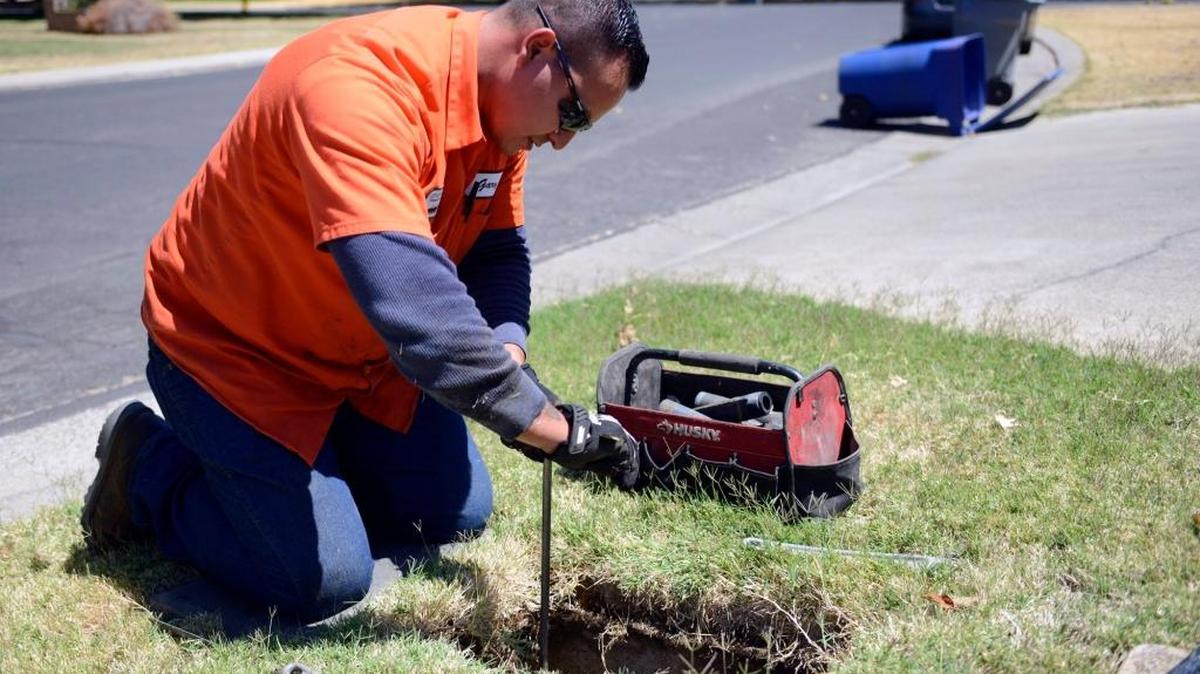 
Merced Water Department worker Gary Ingram, 27, of Atwater installs a water meter in the front of a house on Tenaya Drive in Merced on Aug. 12. Workers began the process of connecting more than 10,000 meters earlier this year.
