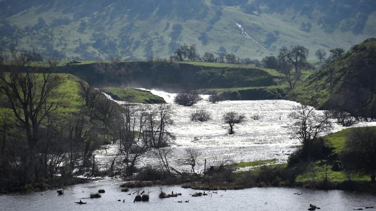 Water is diverted through the spillways of Lake McSwain as the Merced Irrigation District makes releases from Lake McClure to the Merced River on Feb. 13.