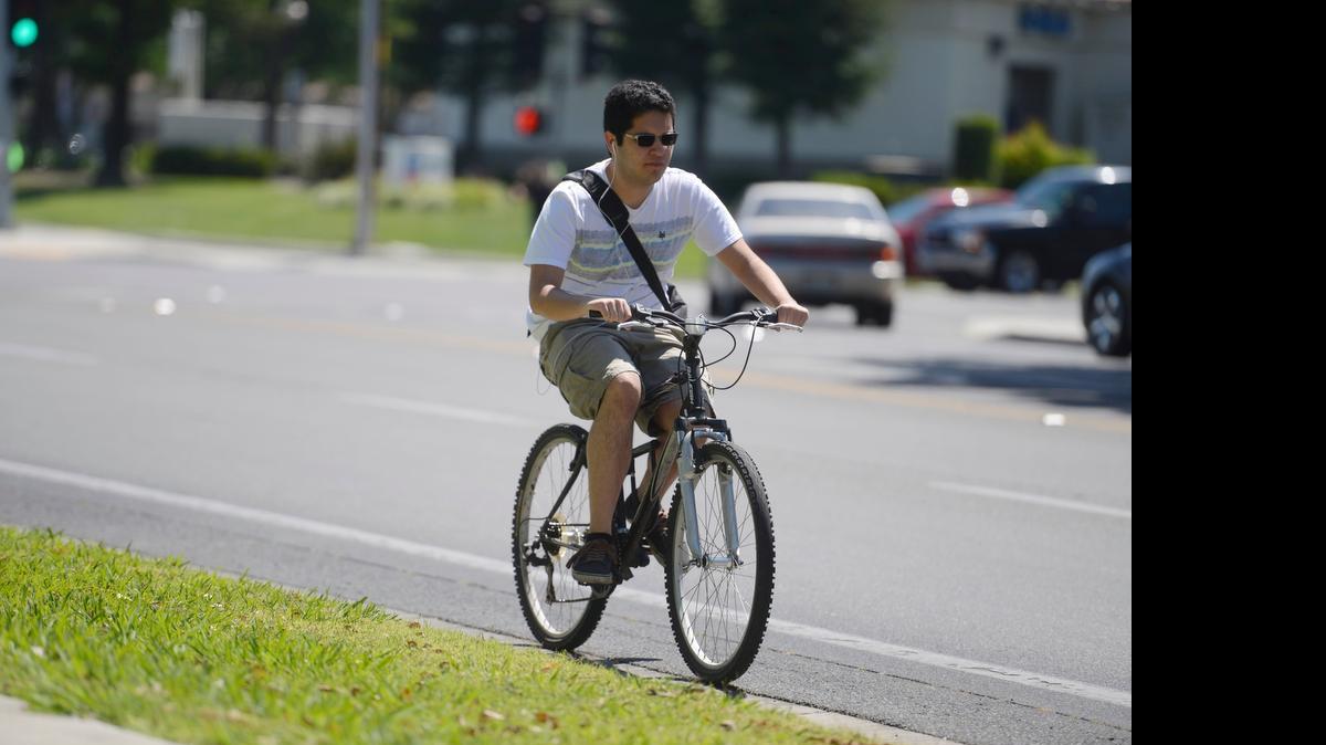 
A cyclists rides his bike on Yosemite Avenue towards Merced College on Monday. May is National Bike Month and a few special observances are planned in Merced next month.
