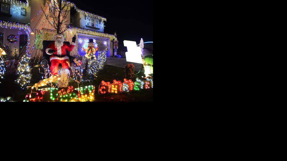 
A mechanical Santa Claus waves his hand at the home of Tom and Melissa Smith, 1298 Verdon Court in Merced. The Smiths have decorated their home with a dazzling light display since 2009. This year the couple has choreographed more than 30,000 lights to music.
