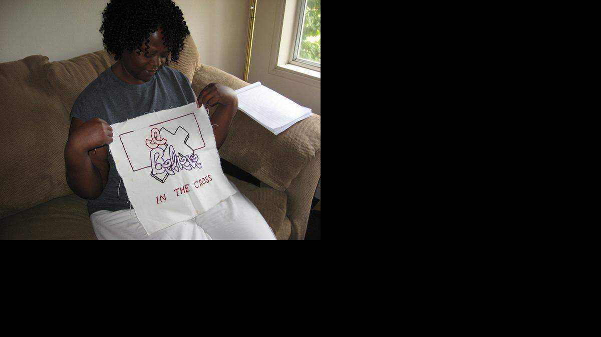 
Elizabeth Brown displays one of her handmade embroideries at her home in Merced.

