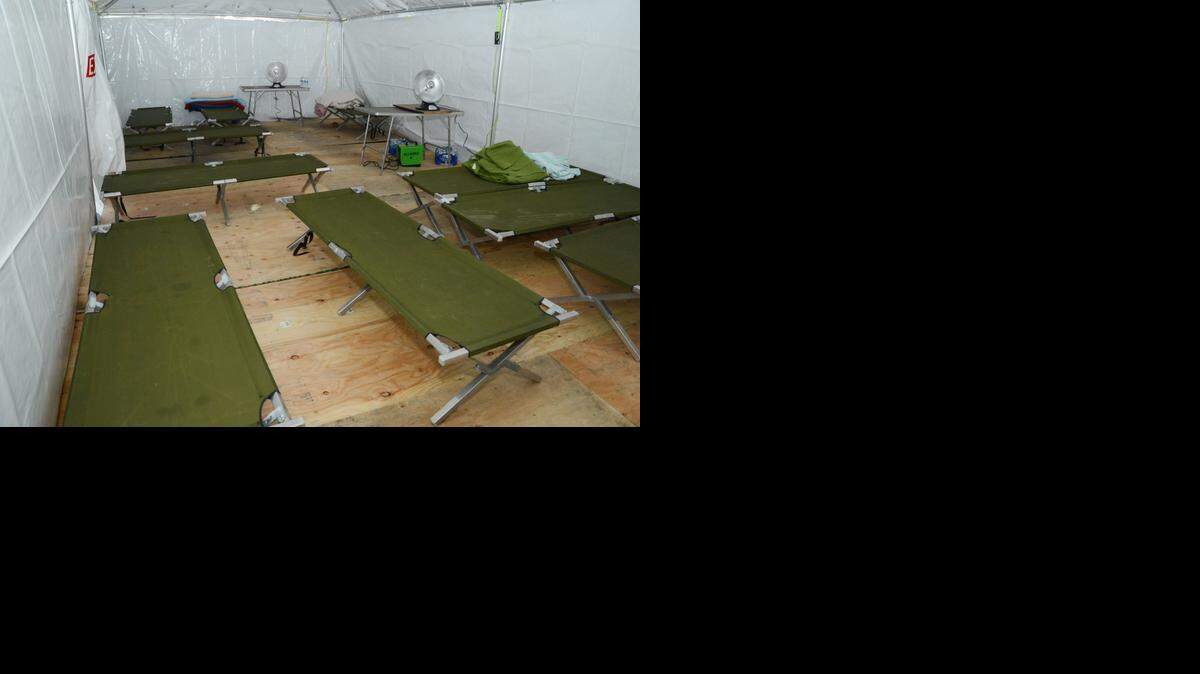 
Merced County Rescue Mission’s 10-cot warming center, seen here in December 2013, was essentially a tarp tent filled with cots and space heaters. 
