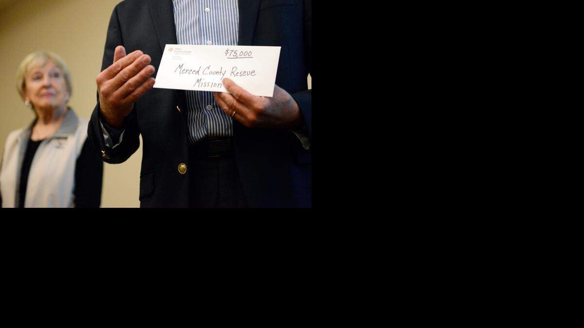 
Merced County Rescue Mission Executive Director Bruce Metcalf holds a $75,000 check his organization received on Tuesday from the philanthropic arm of Dignity Health, the parent company of Mercy Medical Center. It was the largest such donation ever given in Merced County through the program, according to hospital staff. 
