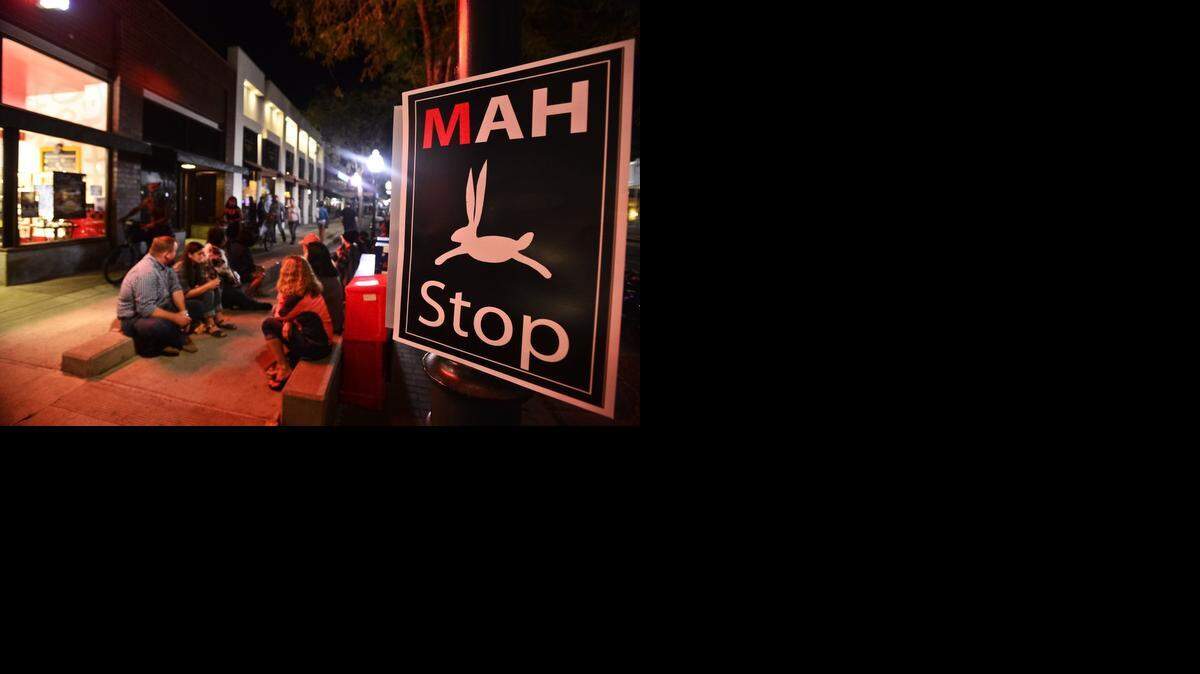 
Pedestrians sit outside Cold Stone Creamery during the Merced Art Hop in downtown Merced in October. 
