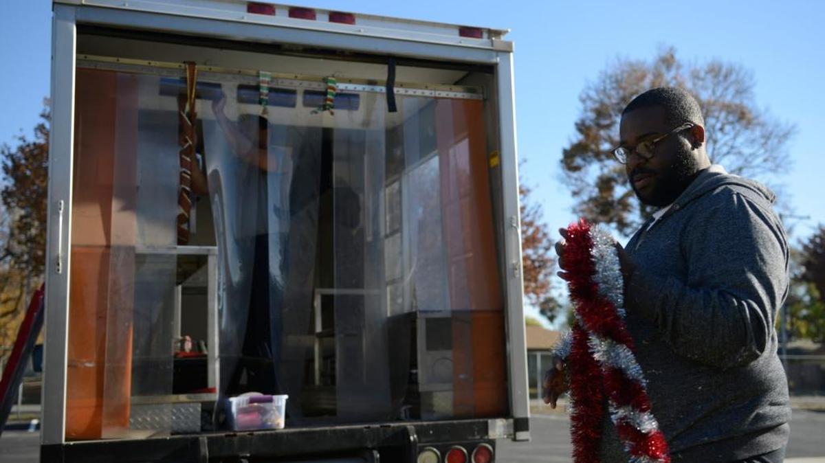 Eugene Davis, 23, a volunteer, twists tinsel Friday to decorate “The Canteen” vehicle in the parking lot of the Salvation Army Corps in Merced. The vehicle will take part in Merced’s Christmas parade Saturday.