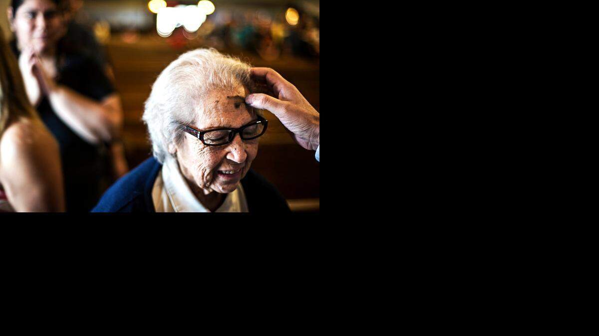 
Consuelo Parez, 85, of Merced has ash placed on her forehead in the shape of a cross during Ash Wednesday Mass at Sacred Heart Roman Catholic Church in Merced.
