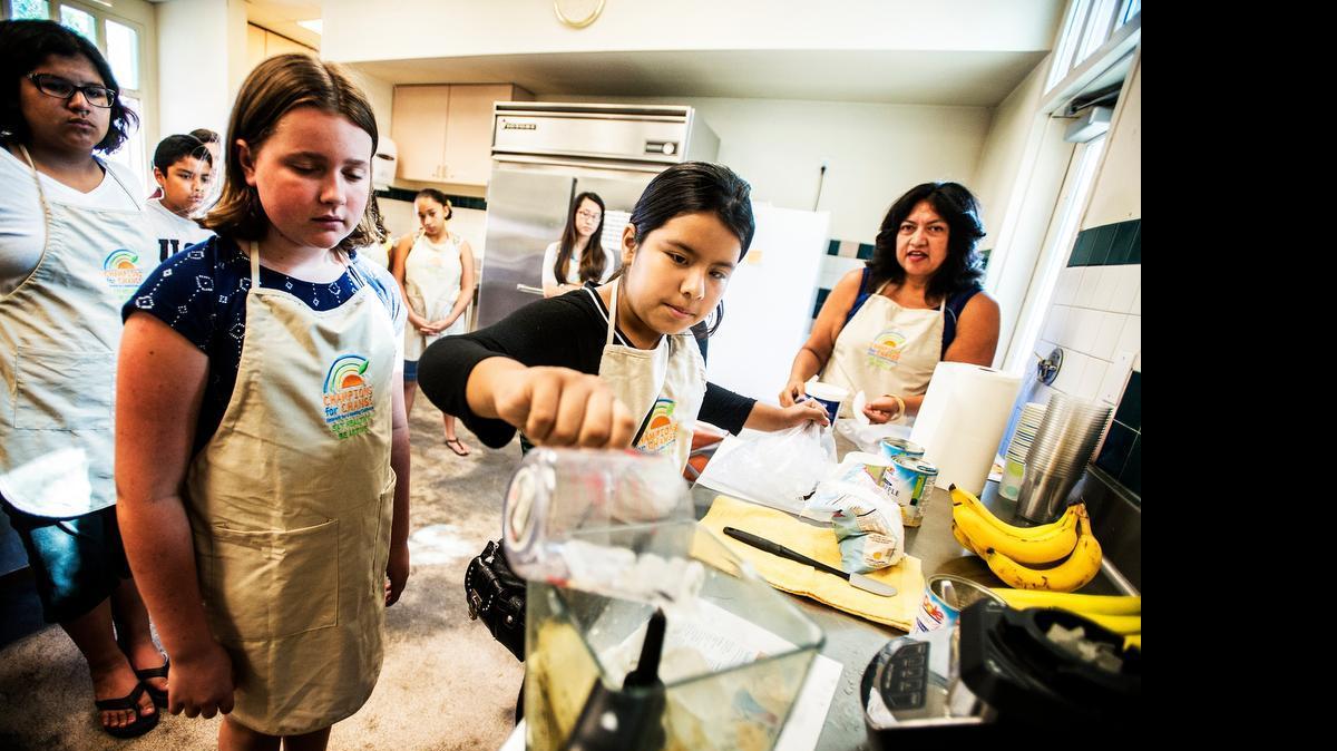 
Emily Martinez, 11, of Merced, adds ice to a smoothie recipe during a Cooking Matters class at the Merced Senior Community Center in Merced, Calif., Thursday, June 25, 2015. The class, which is part of the Healthy Eating and Active Living Resolution, or H.E.A.L., teaches students how to make healthy meals for themselves and family members.
