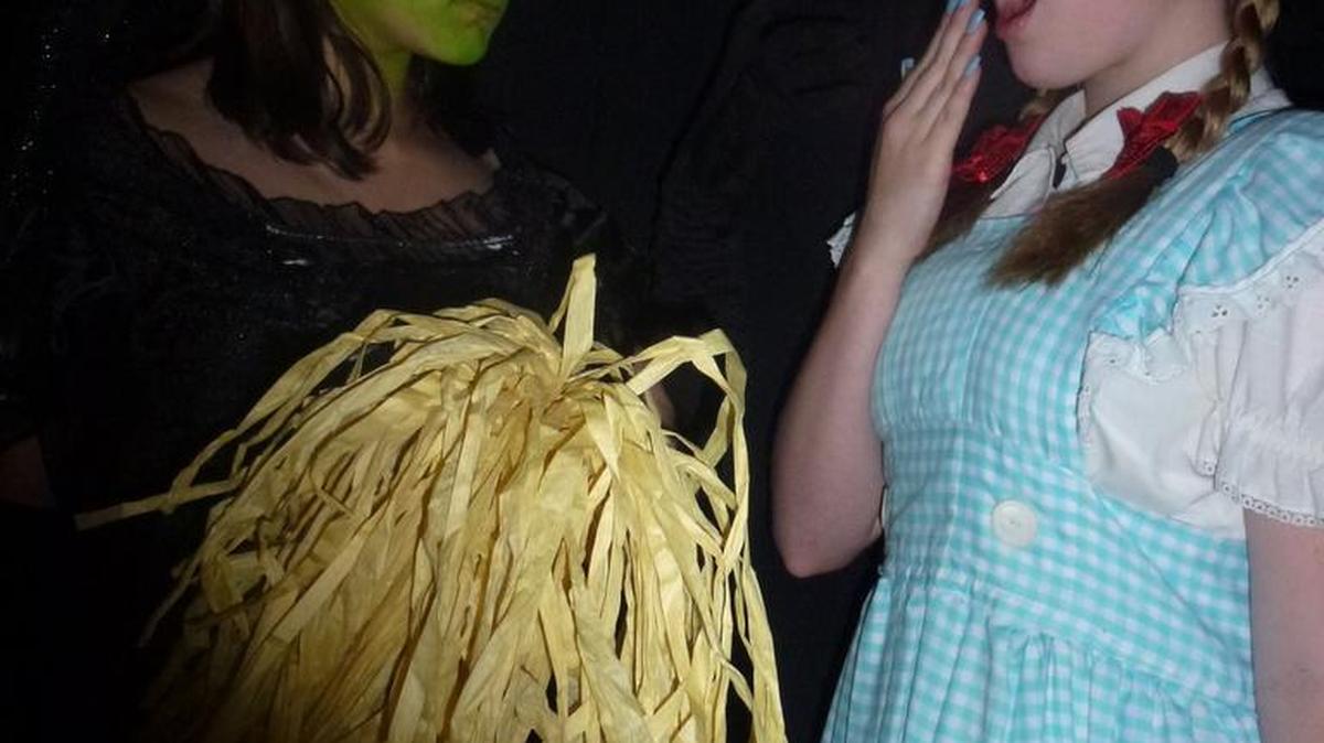 Alyssa Sorci, left, playing the Wicked Witch of the West, and Emmaleigh Irish, as Dorthy Gale, rehearse for Mitchell Senior Middle School’s spring production of “The Wizard of Oz.”