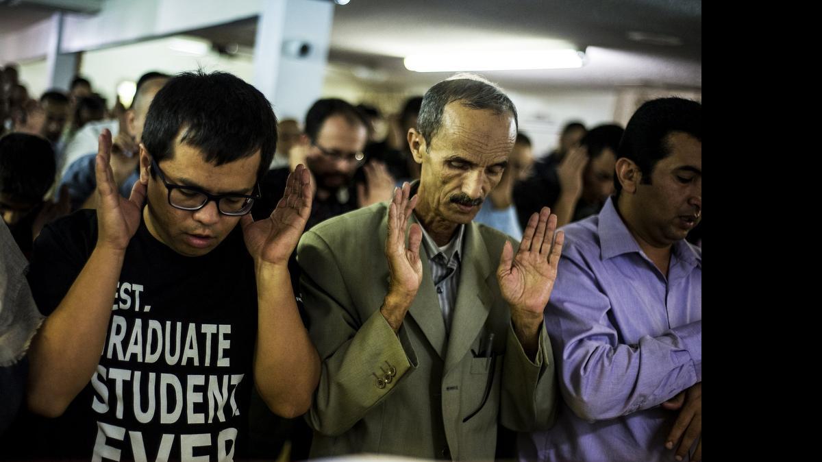 
Hassan Altareb, 55, of Merced, right, prays with fellow Muslim men inside the mosque while observing Eid al-Fitr on Friday at the Islamic Center of Merced on Ashby Road. Eid al-Fitr is a three-day holiday marking the end of Ramadan.
