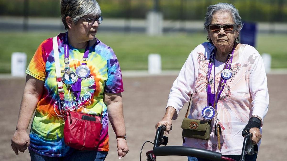Livingston residents Sophia Trujillo, 56, left, and her mother Lily Trujillo, 83, right, walk the track in memory of Lily's sister and Sophia's aunt, Carol, during the Relay For Life at El Capitan High School in Merced, Calif., on Saturday, April 21, 2018.