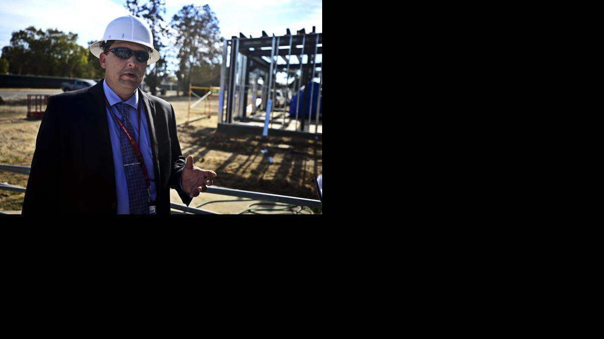 
Brian Johnson, vice president of the Sierra Flight Academy, speaks with media prior to the installation of an 11-ton flight simulator through the roof of the former Castle Science and Technology Center at Castle Air Force Base in Atwateronn Thursday. The roof of the building had to be extended 12 feet to allow enough room for the simulator to operate. The simulator allows students to learn on an exact replica of a Boeing 737 .
