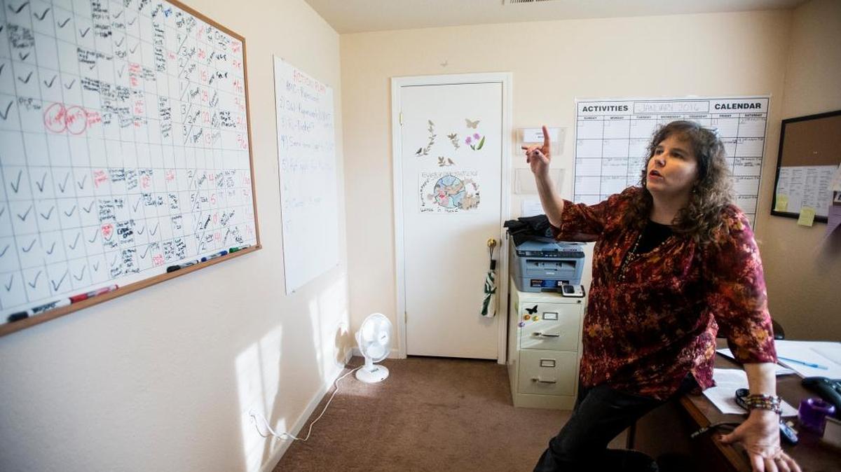 Lisa Hansen, director of Hope Respite Care, speaks about a board used to track client progress at the N Street facility in Merced on Wednesday, Jan. 27, 2016. The home, which opened in 2014, serves as temporary housing for individuals who have been discharged from the hospital but have nowhere else to go.