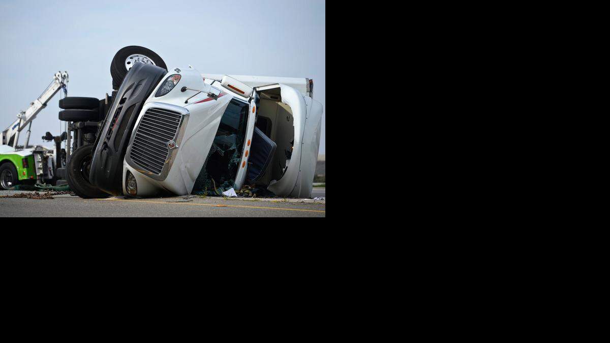
California Highway Patrol and Caltrans crews respond to the scene of a semi-truck rollover in the southbound lanes of Highway 99 at East Mission Avenue in Merced, Calif., Thursday, Jan. 8, 2015. According to the California Highway Patrol, the driver of the truck suffered minor injuries and was transported to Mercy Medical Center Merced.
