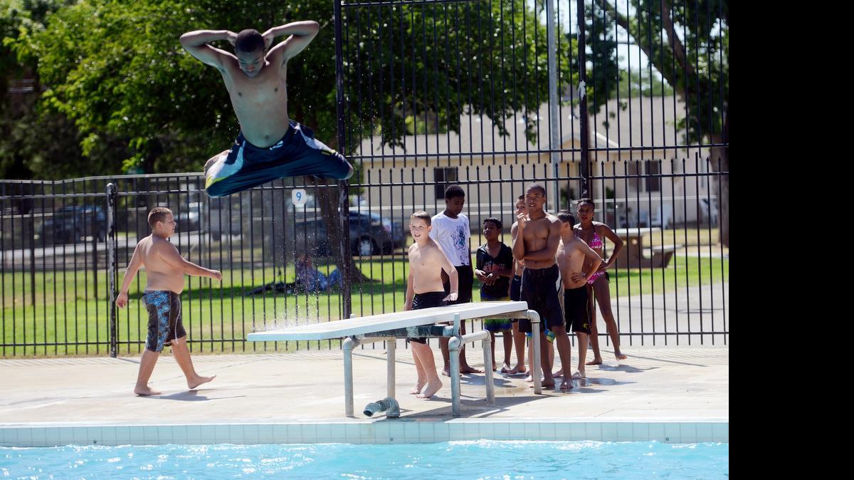 
Young people line up for their turn at the diving board at McNamara Park on Friday. The pool is open for swimming from 3 to 6 p.m. every Thursday through Sunday in June and July. Children swim for $1 and adults are $2.
