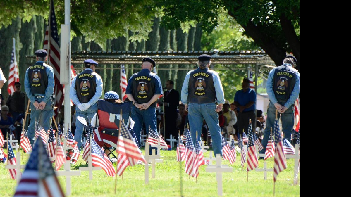 
An array of flags and crosses mark the Merced District Cemetery as the Legion Riders stand at attention during a Memorial Day service held in the veteran’s section of the cemetery last year
