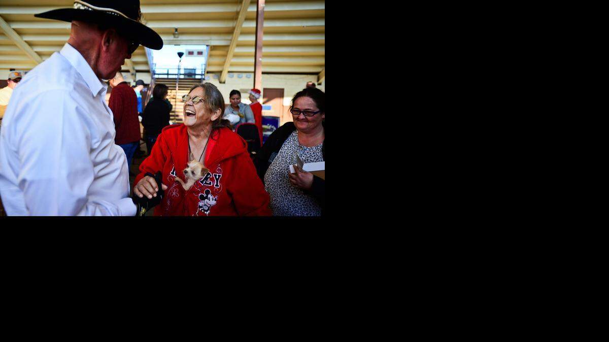 
Peanut the dog watches as owner Donna Nelson, 71, of Merced laughs with Greg Hostetler of Hostetler Ranches during a food giveaway organized by Hostetler and Mike Gallo of Joseph Gallo Farms at the Merced County Fairgrounds on Tuesday.
