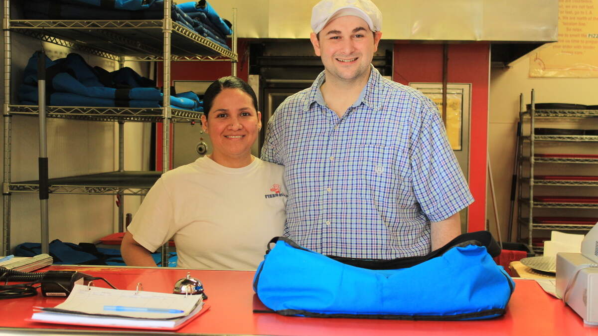 Pizza Villa owners Seth and Alma Fisher are shown.