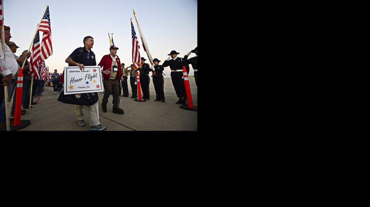 
Veterans aboard the Central Valley Honor Flight for World War II veterans are welcomed home at Castle Airport in Atwater, Calif., Wednesday, Oct. 29, 2014. The flight took more than 60 veterans to Washington, D.C., to visit war memorials.
