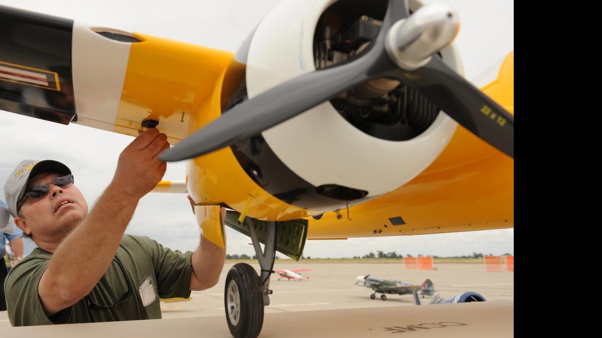 
Terry Fleck conducts a preflight inspection of a model airplane during the West Coast Festival of Giants at Castle Airport in Atwater in 2010.
