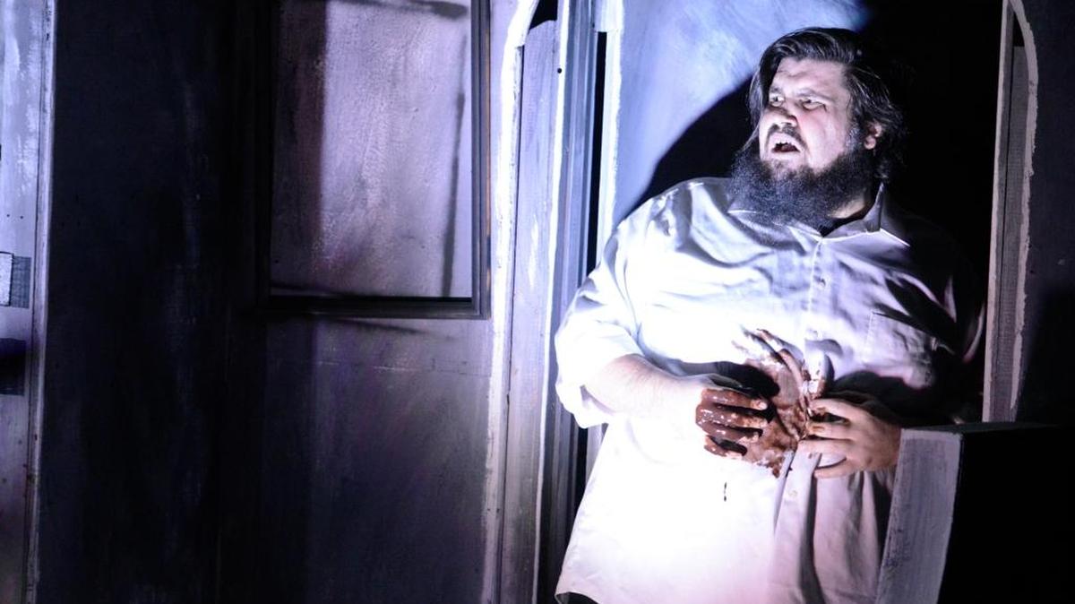 Harry Cooper, played by R.C. Essig, reacts to a gunshot wound from the play's hero during a rehearsal of a live production based on George Romero’s classic “Night of the Living Dead” on Wednesday. The adaptation adds a mixture of comedy to the normally deadly serious story.