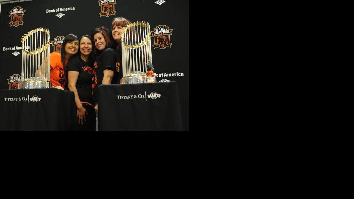 
From left, Mariela Gomez, Crystal Barrera, Vikki Espino and Stephanie Eyberg, all of Merced, have their picture taken with the Giants World Series trophies at the Merced County Fairgrounds in February 2013. The tour will return to the fairground Wednesday.
