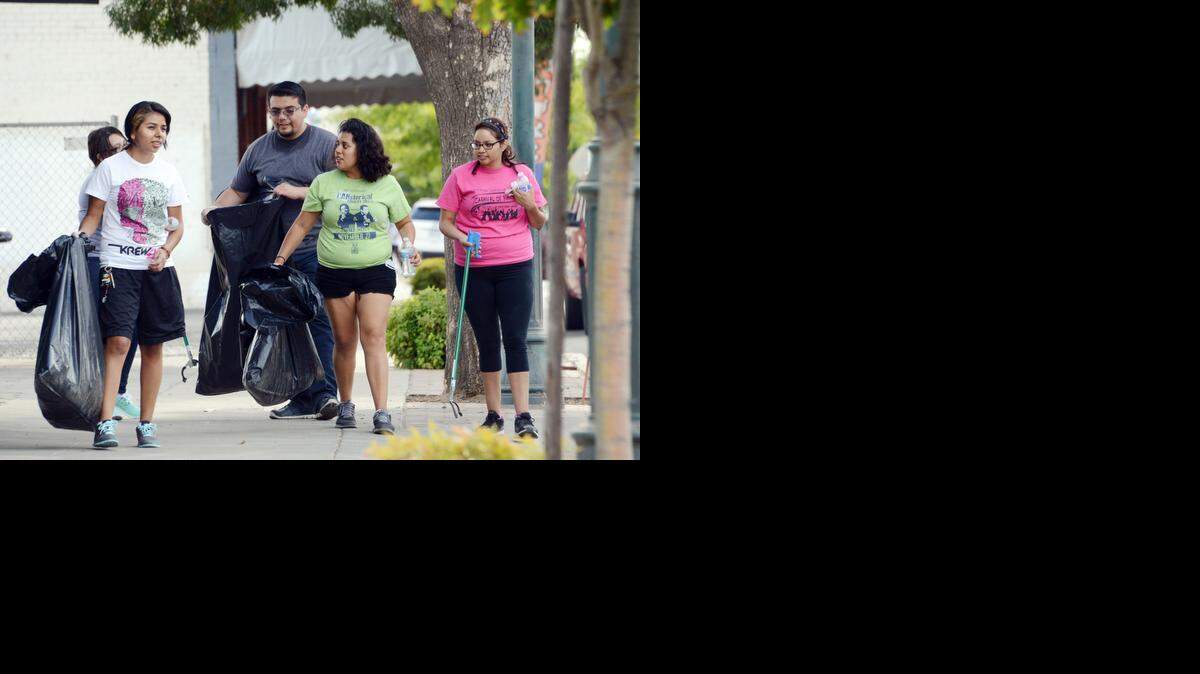 
A group from the UC Merced Police Mentor Program walks Main Street in Merced picking up trash last year as part of Love Merced, a day of service. This year’s Love Merced is planned 9 a.m. to noon on Saturday. 
