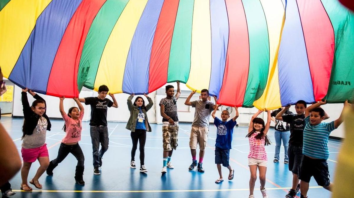 
Members of the Boys and Girls Club of Merced County create a mushroom with a large parachute in Merced, Calif.,  in April. 
