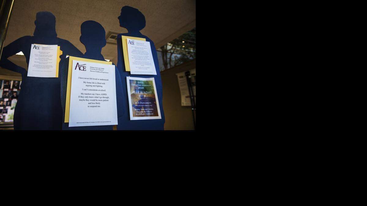 
Blue silhouettes stand in the entrance to Merced’s City Hall on Monday, each representing a victim of child abuse.
