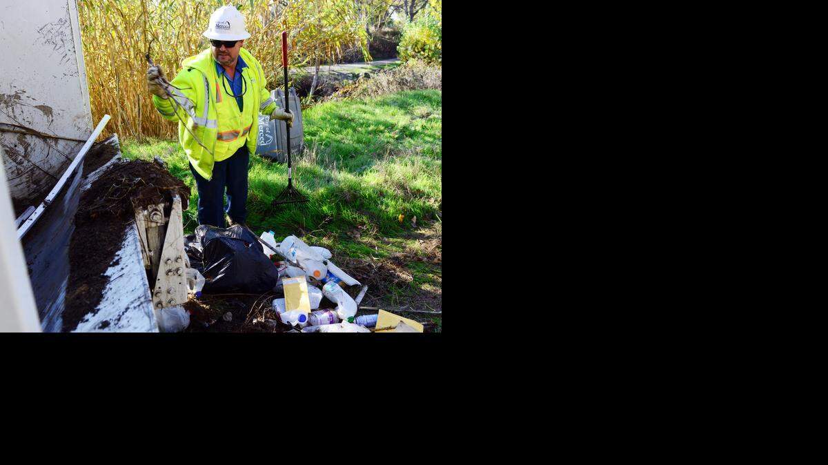 
Todd Foster, an employee of Merced’s Refuse Department, cleans up trash from a homeless encampment along Bear Creek on Monday, November 24, 2014. A crew cleaned out trash and any belongings left behind by people who live under the bridges and in makeshift shelters.
